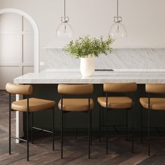 a kitchen with marble counter tops and bar stools next to a plant in a vase