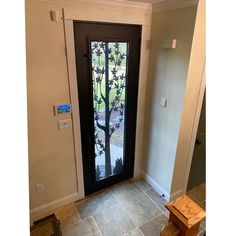 an entry door with a glass paneled tree on it