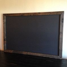 a blackboard sitting on top of a wooden table