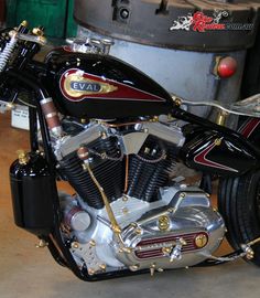 a black and red motorcycle parked in a garage