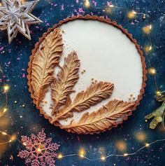 there is a pie decorated with leaves and snowflakes