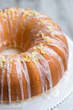 a bundt cake with lemons and icing sitting on a white platter