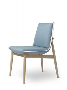 an upholstered chair with blue fabric and wooden legs