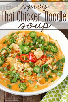 thai chicken noodle soup in a white bowl with green peppers and red bell peppers