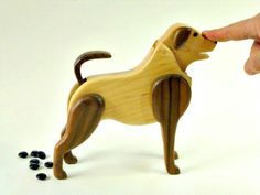 a wooden toy dog standing next to some black beads