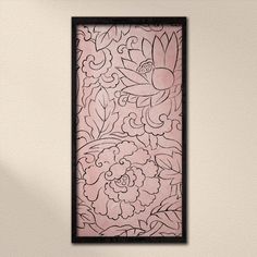 a pink and black framed artwork hanging on the wall