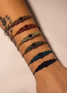 a woman's arm with several bracelets on it