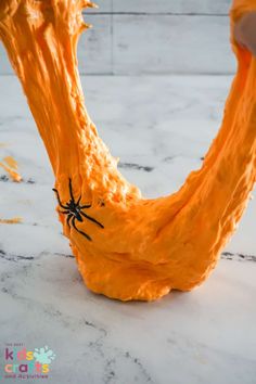 a spider crawling on the side of an orange object