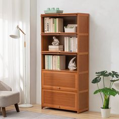 a living room with a chair and bookcase in it's corner, next to a potted plant