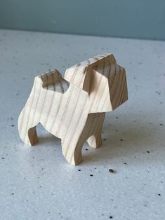 a wooden toy elephant sitting on top of a table