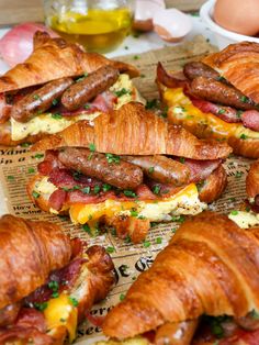 there are many croissants with bacon and eggs in them on the table