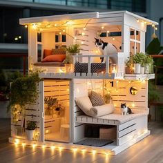 a doll house with lights on the roof and furniture in the porch area, as well as a cat