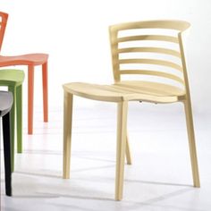 four different colored chairs sitting next to each other