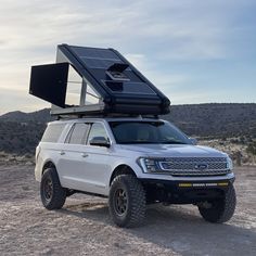 an off road vehicle with a solar panel on it's roof