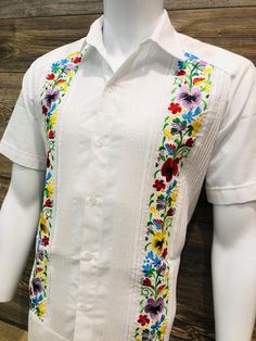 Mexican Guayabera.  Beautiful and Elegant.  Handcrafted in Merida, Yucatan Mexico. Made out of Cotton Polyester Blend Floral Multi Color Hummingbird Flower Embroidery  Two Embroidery Panels No Pockets  Short Sleeve.  Beautiful and Elegant Guayabera Wedding Shirt.  Traditional Mexican Shirt  Good for Casual wear, Wedding, Fiesta, Tropical, Birthday, Father Day, Special Event/Day etc.  100% Brand New  Please refer to size chart for proper fitment.  We gladly accept returns and exchanges with these terms and conditions.  We do charge a 25% Fee on any returns. This helps compensate for shipping fees, packing supplies and labor costs.  Exchanges have no cost.  Customer is responsible for shipping items back.  We do not provide prepaid labels.  Items should be returned just as received and with Guayabera Wedding, Mens Wedding Shirts, Traditional Mexican Shirts, Mexican Shirts, Hummingbird Flowers, Yucatan Mexico, Tee Dress, Mens Shirt Dress, Shorts With Pockets