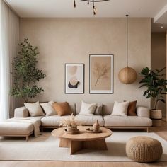 a living room filled with lots of furniture next to a wall mounted planter and potted plants