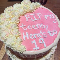 a birthday cake with white frosting and pink icing