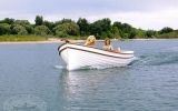 two dogs are riding on the back of a boat in the middle of the water