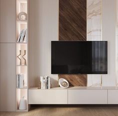 an entertainment center with a flat screen tv mounted on it's side, in front of a white wall