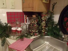 a kitchen sink with christmas decorations on the counter