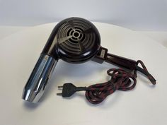 Introducing our exquisite 1950s Vintage Thermor Blow Dryer - a treasure from the past that not only whispers tales of elegance and style but also stands as a testament to timeless engineering. This meticulously preserved Thermor blow dryer isn't just an appliance; it's a slice of history that you can own, display, and yes, even use! Whether you're a collector, a lover of all things vintage, or someone who appreciates the beauty in everyday objects, this piece is sure to captivate. Its charming d Vintage Barbershop, Blow Dryer, Conversation Starters, Everyday Objects, 1950s Vintage, Vintage Beauty, Looks Vintage, Hair Styling, Barber Shop