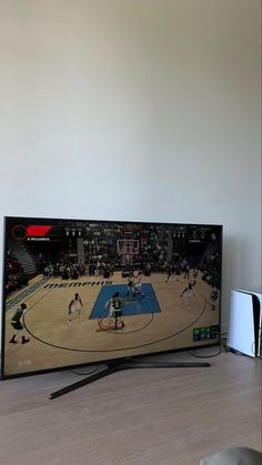 a flat screen tv sitting on top of a wooden table