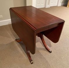 a wooden desk sitting on top of a carpeted floor