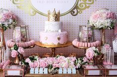 a pink and gold princess birthday party with cake, candy bars, flowers and decorations