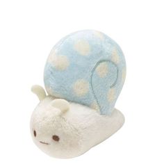 a white and blue stuffed animal snail with polka dots on it's shell, sitting against a white background