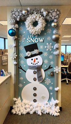 an office cubicle decorated for christmas with snowman and wreaths on the door