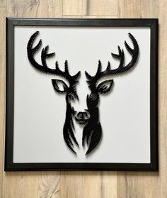 a black and white deer head with antlers cut out of it