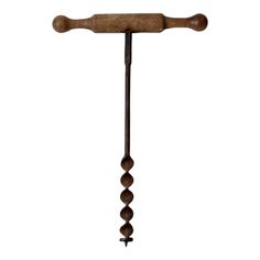 an old fashioned wooden handle with beads hanging from it's end, on a white background