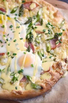 a pizza topped with an egg, cheese and asparagus