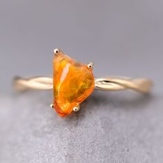 Mexican Fire Opal Twist Band Engagement Ring 18K Yellow Gold. Free Domestic USPS First Class Shipping! Free Gift Bag or Box with every order!Opal—the queen of gemstones, is one of the most beautiful gemstones in the world. Every piece of opal is unique in its own ways and patterns. We only use high-quality Natural Opals (NO synthetics or imitations) for our jewelry. ----------------------------------------------------------------------------------------------------ABOUT THIS PRODUCTSolid 18K Yellow GoldMexican Fire Opal, 0.61 ctOpal Size: 8 x 6 mmRing Size: 7Opal Color: Reflects Bright Orange and Yellow Colors.Occasion: Engagement / Wedding ----------------------------------------------------------------------------------------------------RING RE-SIZINGThere will be no re-sizing fee for cu Orange Wedding Ring, Twisted Band Engagement Ring, Promise Bracelet, Opal Birthstone, Australian Black Opal, Beautiful Gemstones, Mexican Fire Opal, Opal Engagement Ring, Fire Opal Ring