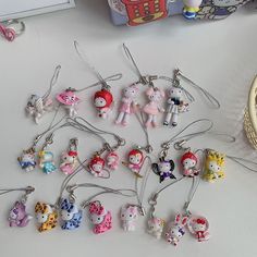 a bunch of hello kitty keychains on a table