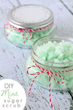 two jars filled with green bath salts on top of a table