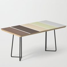 a wooden table with four different colored sections on the top and one black metal frame