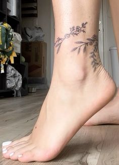 a close up of a person's foot with flowers on it