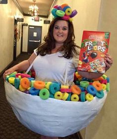 a woman in a white shirt holding a book and wearing a fake fruit bowl costume