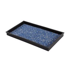 a blue and black tray with gold dots on the bottom, in front of a white background