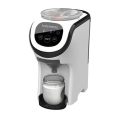 a white coffee maker sitting on top of a counter next to a jar of milk