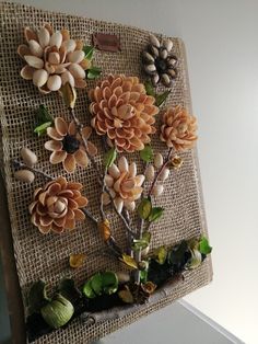 a bunch of fake flowers on a burlap board