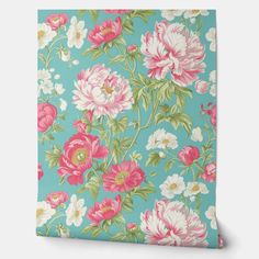 a blue floral wallpaper with pink and white flowers on the front, green background