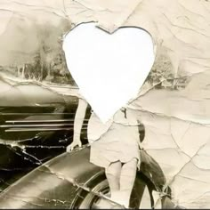 an altered photograph of a child standing next to a car with a heart cut out of it