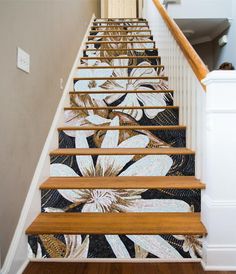 the stairs are decorated with an artistic flower design and wood handrails, along with carpeted flooring