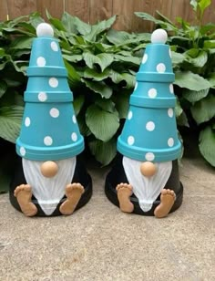 two blue and white gnomes sitting next to each other