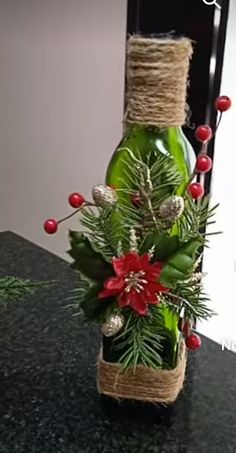 a bottle filled with christmas decorations on top of a table