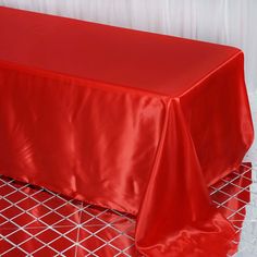 a red table cloth on top of a metal rack