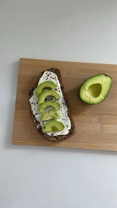 an open face sandwich with avocado slices and cream cheese on toasted bread