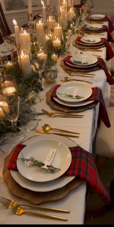 the table is set with candles and place settings